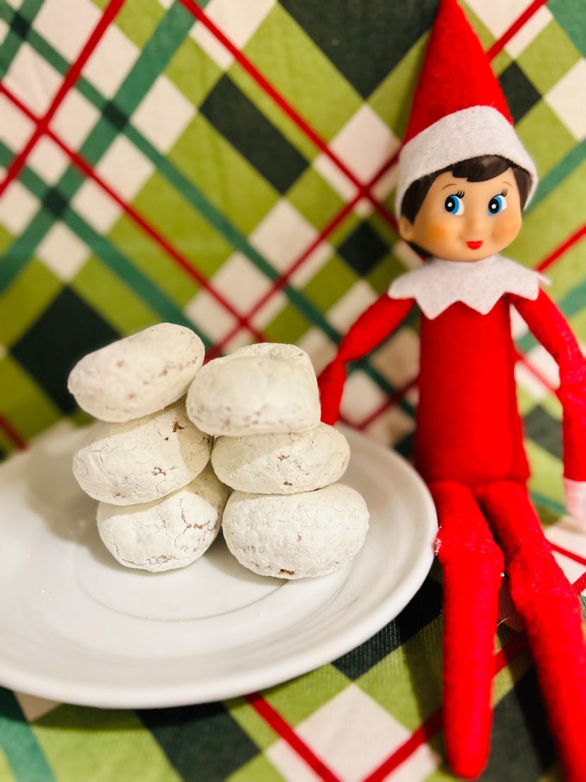 elf on the shelf next to some donuts