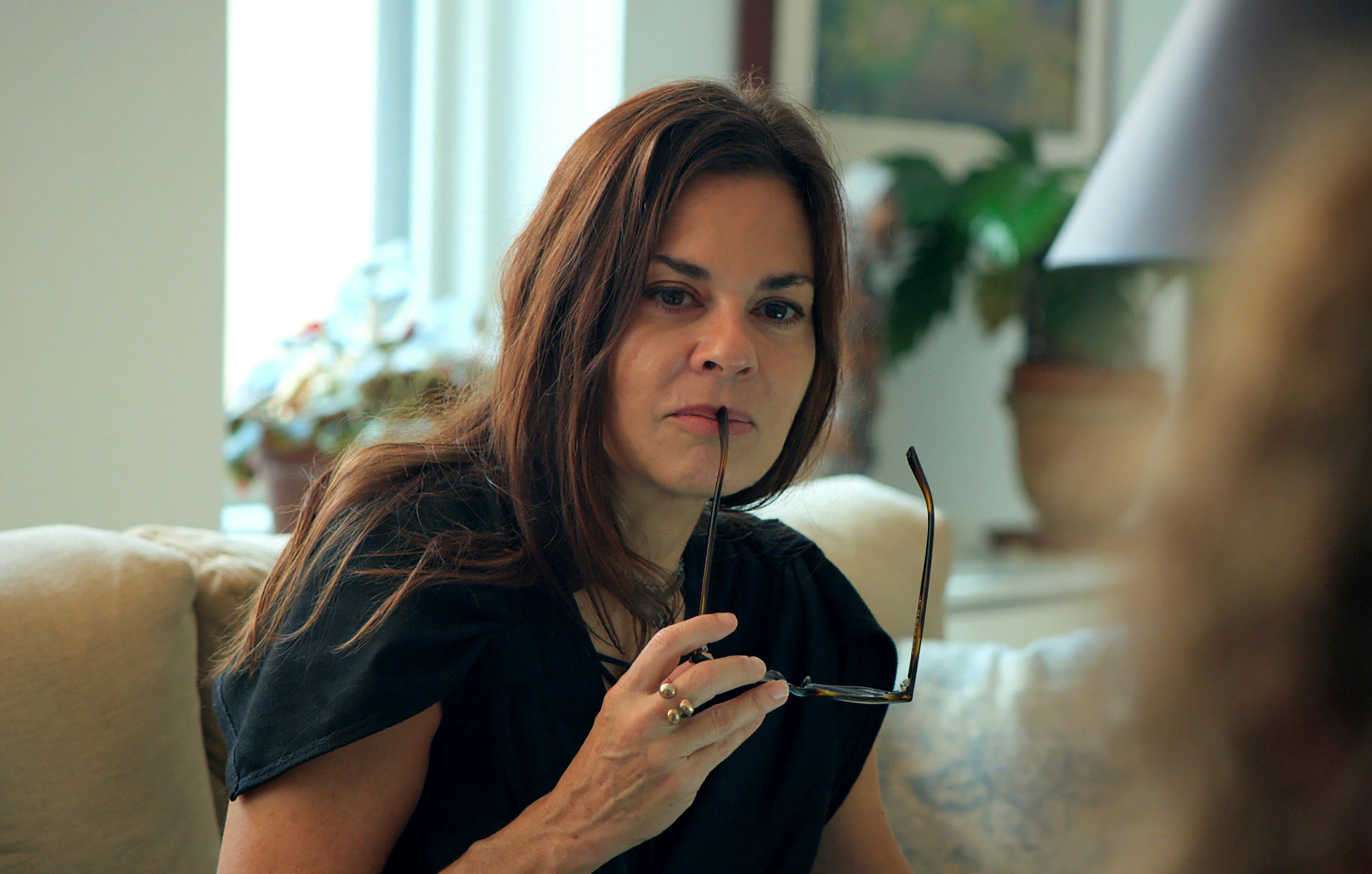 A still from Showtime&rsquo;s Couples Therapy, with host Dr. Orna Guralnik holding reading glasses