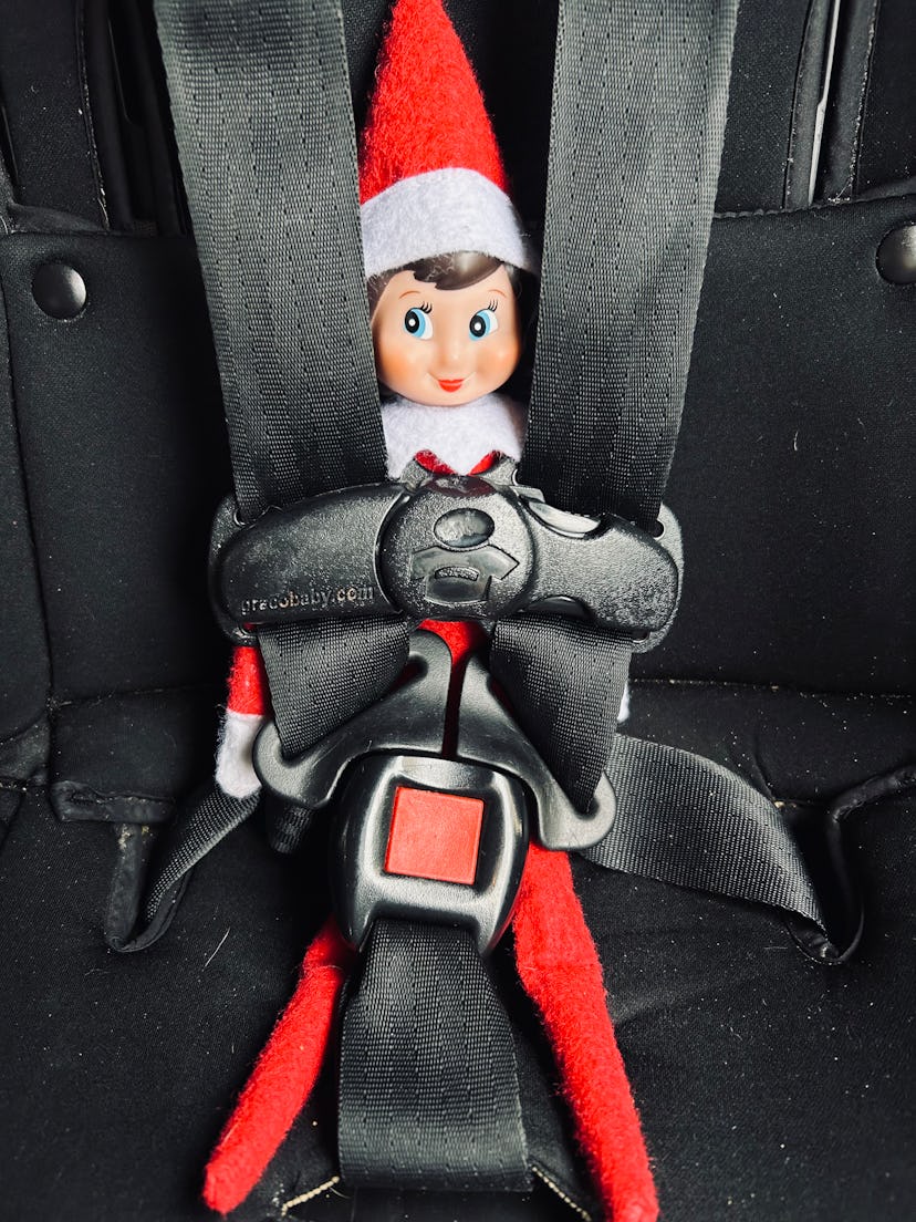 elf on the shelf buckled up in a carseat