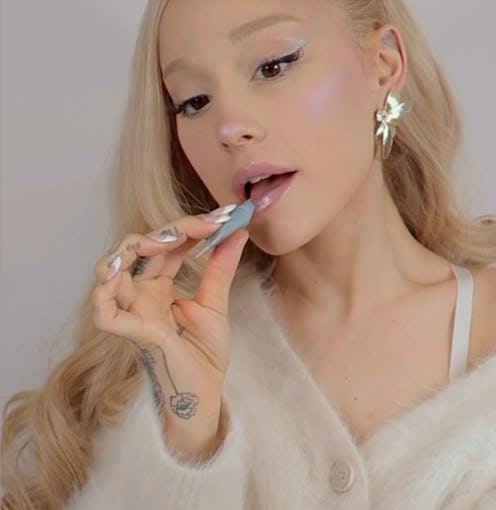 Ariana Grande applying lip product