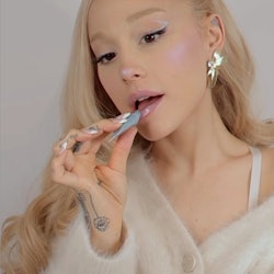 Ariana Grande applying lip product