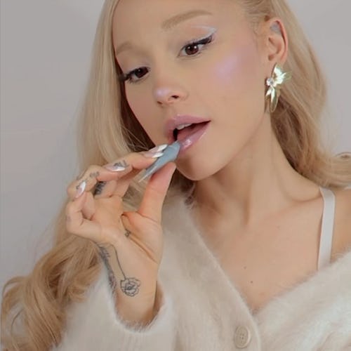 Ariana Grande applying lip product