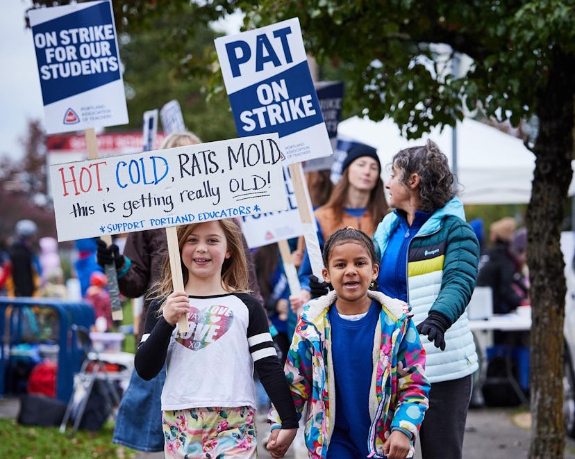 Two kids picketing with signs to support Portland teachers