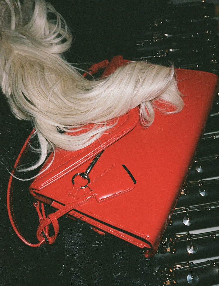 Red leather bag on flutes