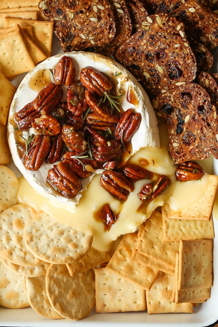 Baked brie with maple syrup and pecans, a shareable Thanksgiving appetizer.