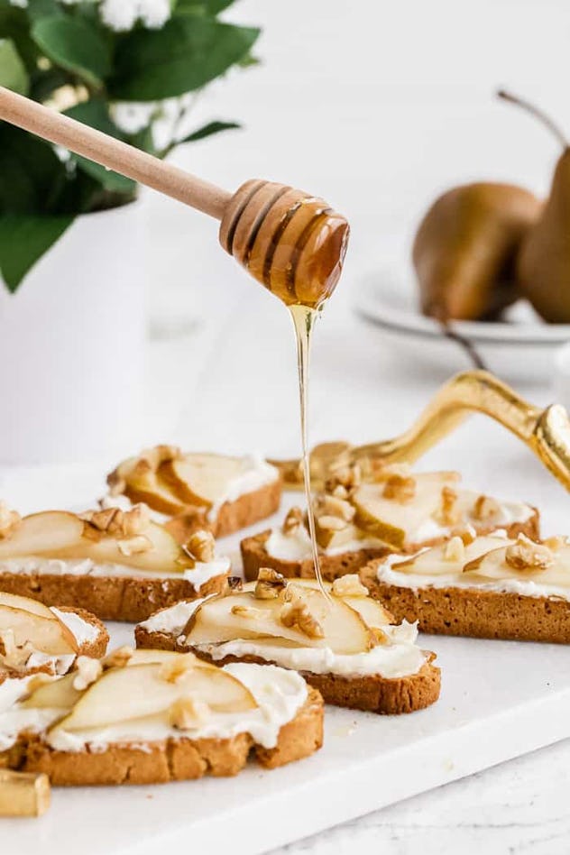 Crostini topped with whipped honey and goat cheese, an easy Thanksgiving appetizer.