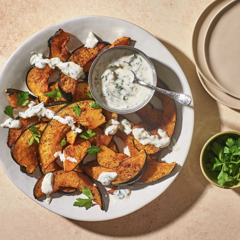 Roasted Acorn Squash Wedges with Garlic-Herb Sauce, a vegetarian Thanksgiving appetizer.