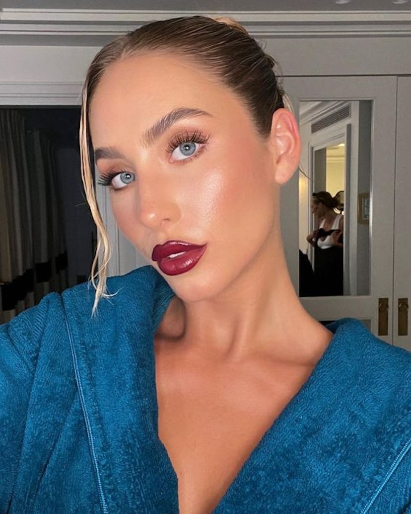 Alix Earle's wine red lipstick is an easy & simple Thanksgiving makeup look for 2023, according to m...