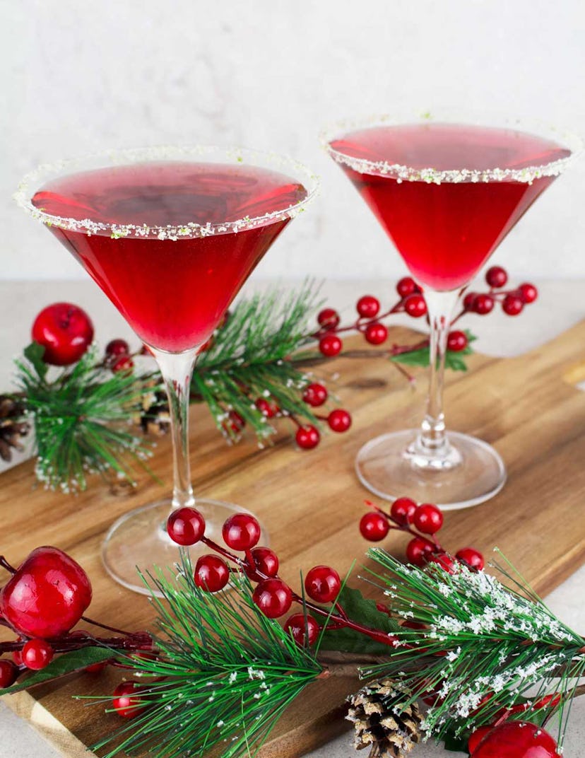 virgin cosmopolitan mocktail with christmas garnish around it by The Mindful Mocktail