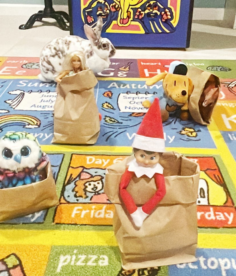 elf on the shelf competing in a sack race with other dolls and stuffed animals