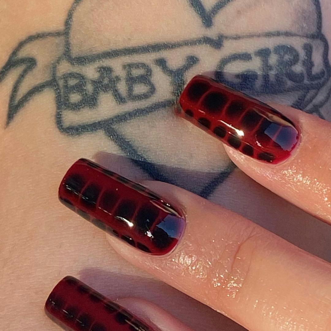 &ldquo;Cherry mocha&rdquo; crocodile print nails are an on-trend manicure idea for Sagittarius season 2023.