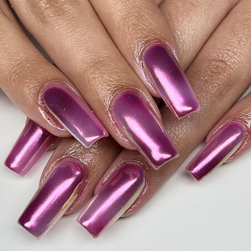 Pink chrome nails are an on-trend manicure for winter 2024.