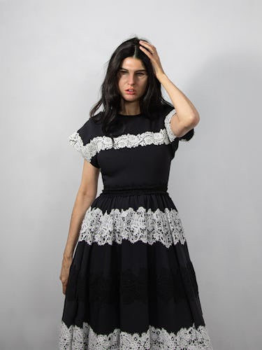 Artist Gillian Wearing wears a black and white dress.