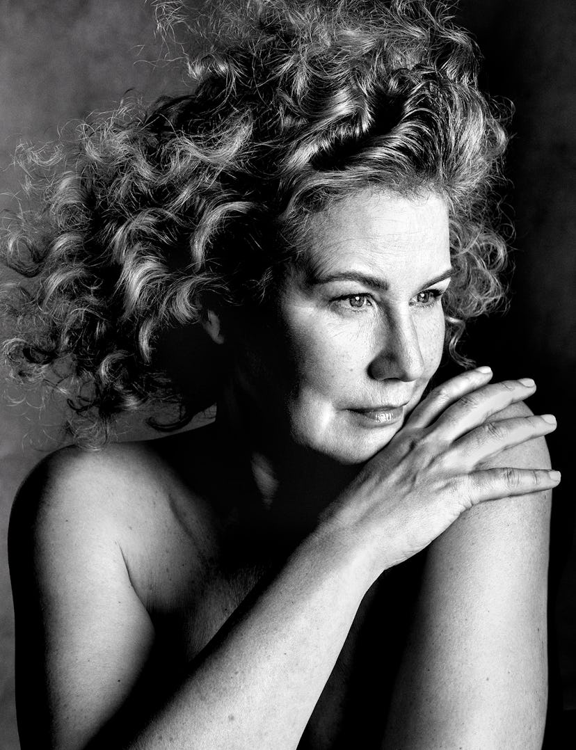 a black and white image of a woman with curly hair