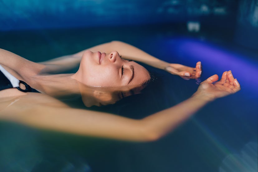 Woman floating in sensory deprivation tank, a gift card for which is , one of the best Christmas gif...