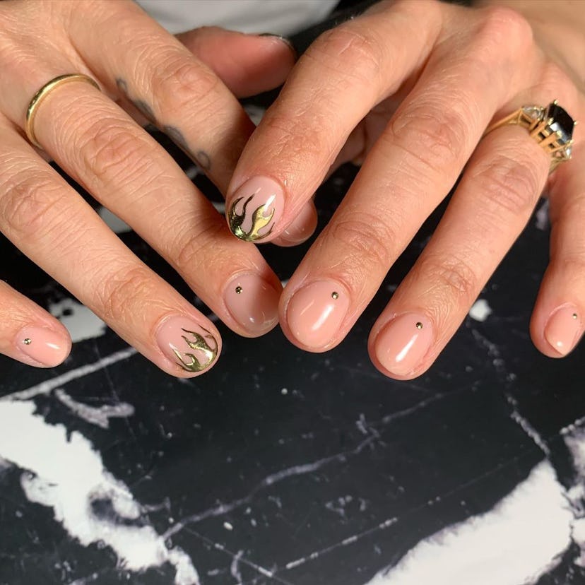 Minimal nails with gold chrome flame details are an on-trend manicure idea for Sagittarius season 20...