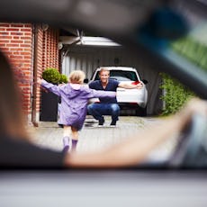 A mother drops her child off at her ex-husband's house.