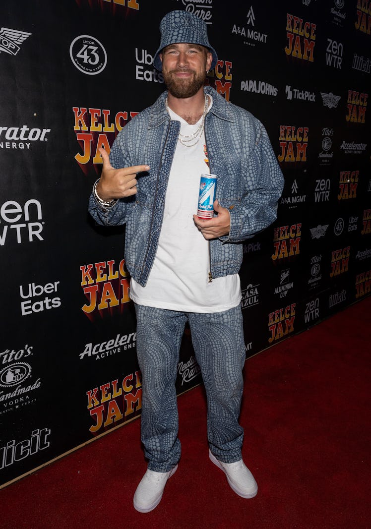 Travis Kelce wearing denim-on-denim: a denim jacket with matching denim jeans.