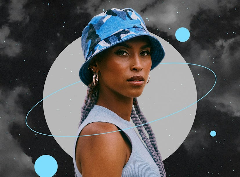 Young woman wearing a blue hat before reading her December 2023 horoscope.