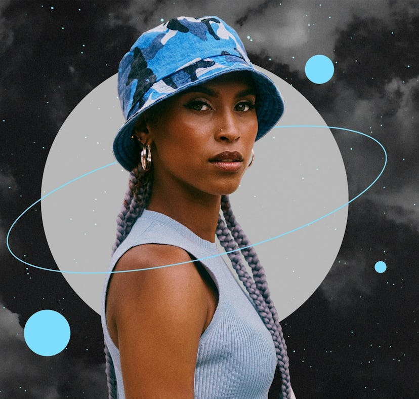 Young woman wearing a blue hat before reading her December 2023 horoscope.