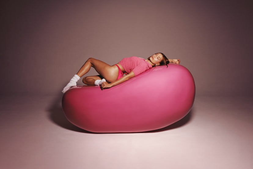 Hailey Bieber’s ad for Rhode’s new Peptide Lip Tint in Jelly Bean.