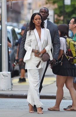 Rihanna wears a white suit and a Gucci Soho Disco.