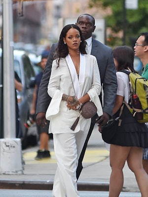 Rihanna wears a white suit and a Gucci Soho Disco.