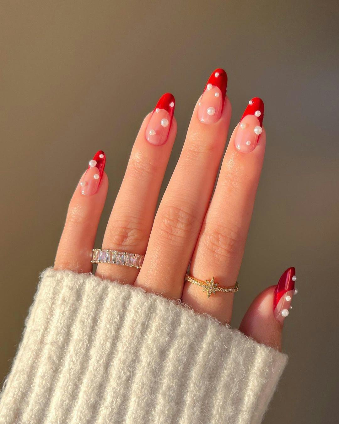 For a simple Christmas nail design for the 2023 holiday season, red French nails and pearls are easy&hellip;