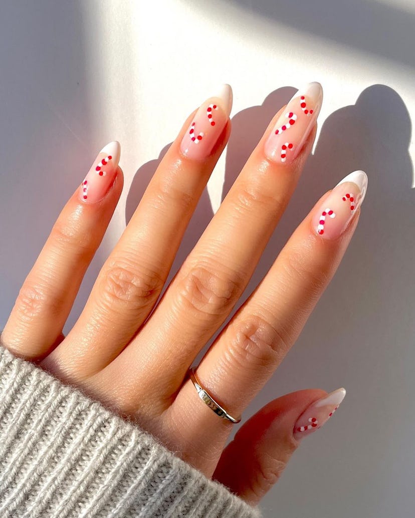 For a simple Christmas nail design for the 2023 holiday season, micro candy cane nail art is trendy ...