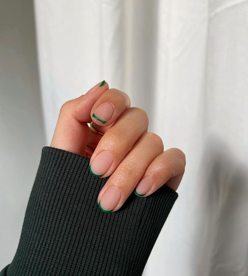 For a simple Christmas nail design for the 2023 holiday season, emerald green micro French tips are ...