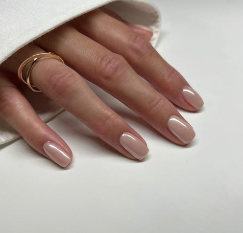 Nude chrome nails are the neutral 2024 nail art trend for the ultimate "clean girl."