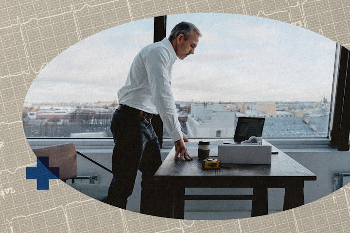 A man standing at his desk in his office.