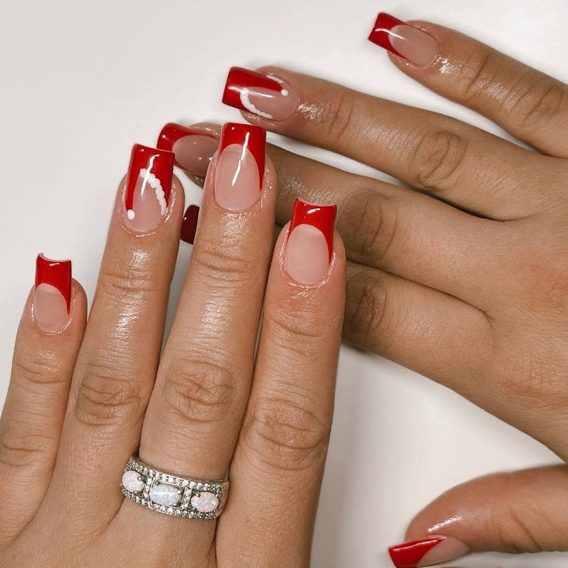 For a simple Christmas nail design for the 2023 holiday season, red French Santa's hat nails are tre...