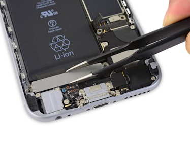 A Taptic Engine getting pulled out of an iPhone 6S
