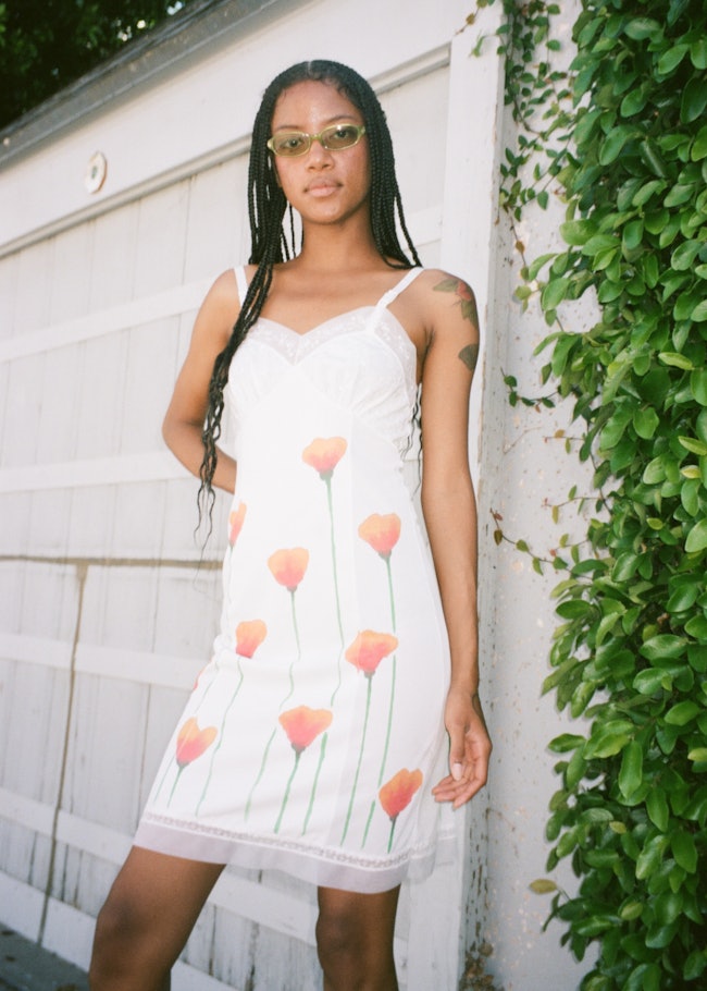 A model wearing a dress featuring Keely Murphy's most popular print, poppies.