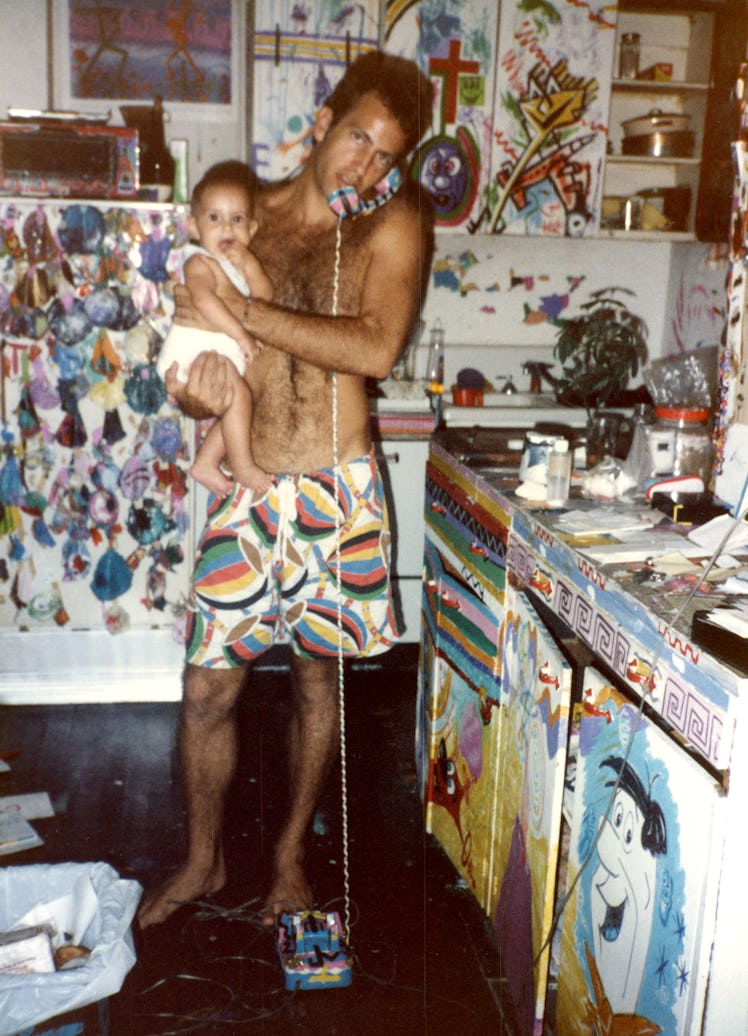 Kenny Scharf with his first child as a baby in his east village apartment