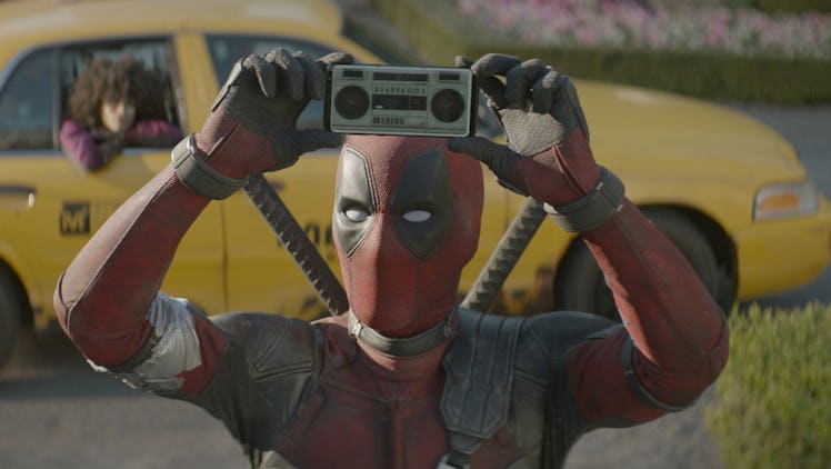 Wade Wilson (Ryan Reynolds) holds up a mini boombox in 'Deadpool 2'
