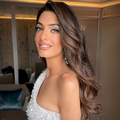 Amal Clooney curled hairstyle and one-shoulder dress