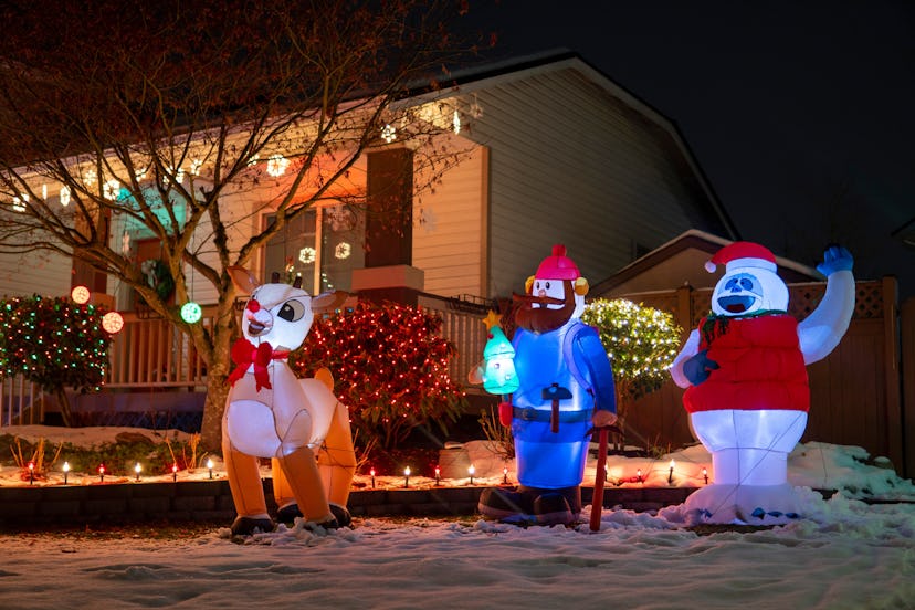 Christmas inflatables lit up at night, in a story answering the question, is it safe to leave outdoo...