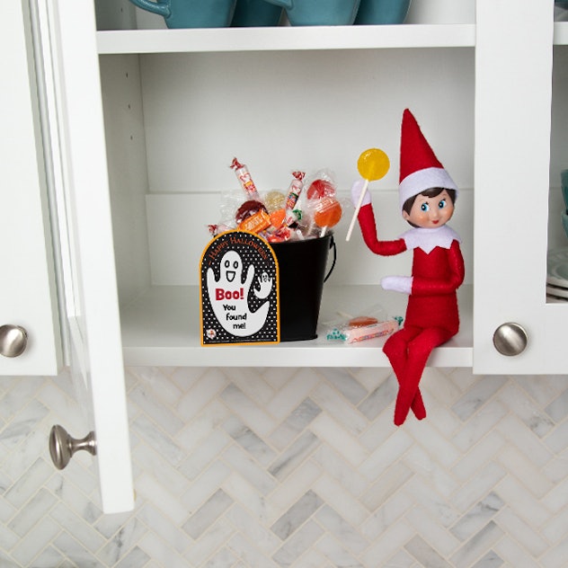 naughty elf on the shelf ideas - stealing candy from the halloween stash