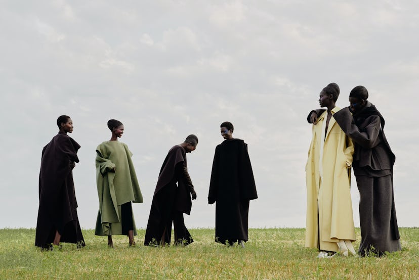 Models wearing coats from the Fall 2023 runways in an open field.
