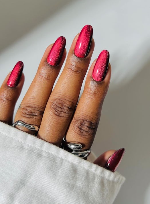 Red chrome nails will be a popular holiday nail trend for 2023.