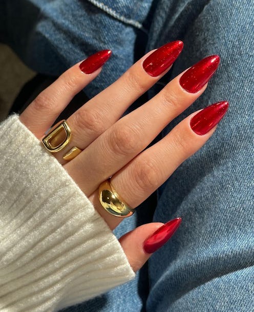 Red chrome nails will be a popular holiday nail trend for 2023.