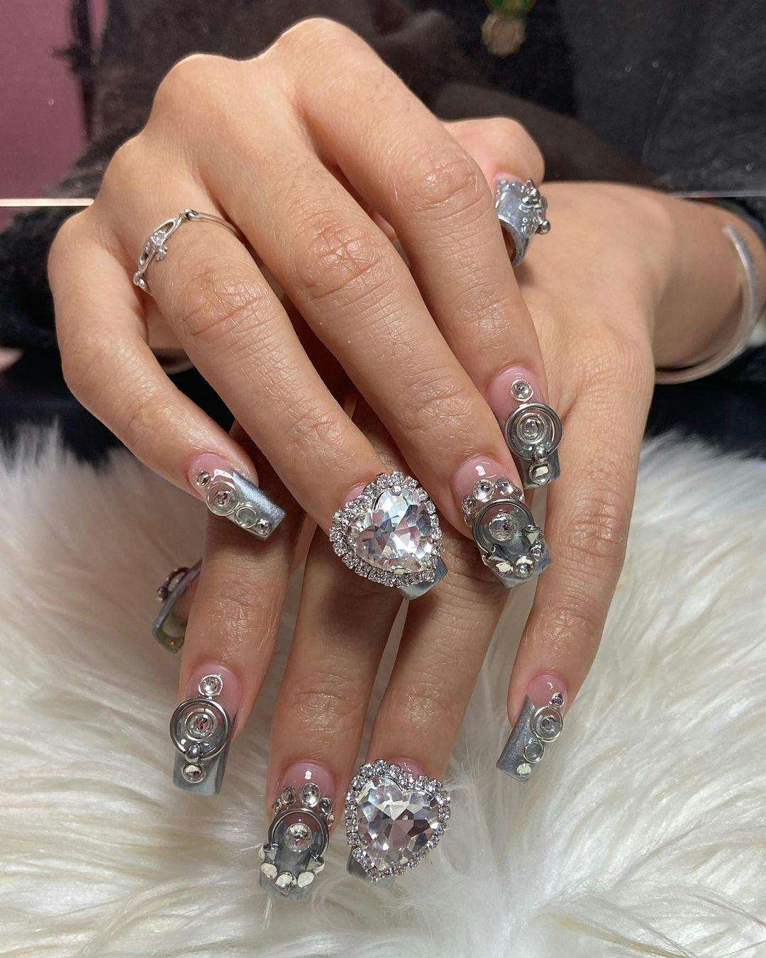 &ldquo;More is more&rdquo; silver gems and crystals that match the 3D chrome nail art trend.