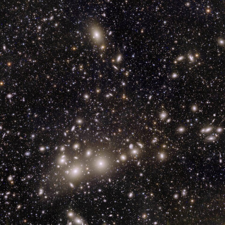 This square astronomical image shows thousands of galaxies across the black expanse of space. The cl...