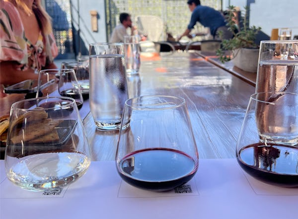 A wine tasting on the patio at Prisoner Wine Company — featuring a glass of white wine and two glass...
