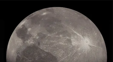 A grayscale moon with a cracked icy surface on a black background.