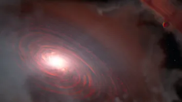 Left of center, a bright light source illuminates a surrounding disc colored dusky red. The disc is...