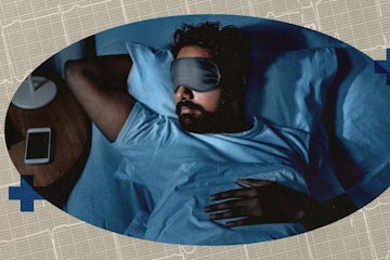 A man in a sleep mask in bed.