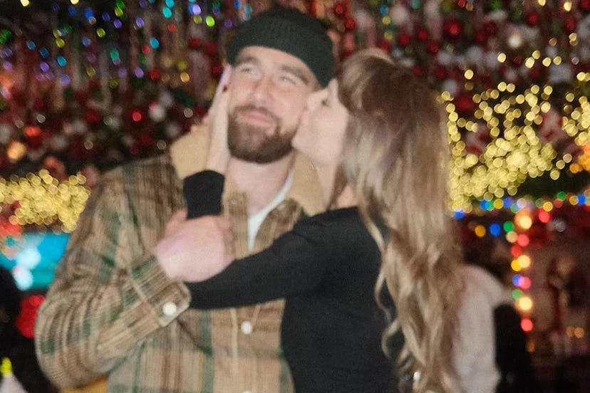 Travis Kelce and Taylor Swift share a kiss on Instagram.